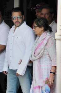Bollywood actor Salman Khan walks with his mother Sushila Charak as he leaves home for court in Mumbai, India, Wednesday.